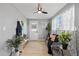 Inviting sitting area with plants, neutral decor, and ample sunlight, creating a cozy and serene atmosphere at 4607 Kennedy Dr, New Port Richey, FL 34652
