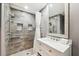 Stylish bathroom features tiled shower with built-in niche and sleek white vanity at 4856 Alamo Ct # 4856, New Port Richey, FL 34655
