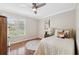 Cozy bedroom with hardwood floors and bright window with plantation shutters at 4856 Alamo Ct # 4856, New Port Richey, FL 34655