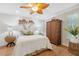 Comfortable bedroom with a tropical ceiling fan, wood-look flooring and decorative palm tree accents at 4856 Alamo Ct # 4856, New Port Richey, FL 34655
