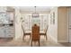 Bright dining area with tile floors, chandelier, and white cabinets near the kitchen at 4856 Alamo Ct # 4856, New Port Richey, FL 34655