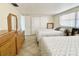 Comfortable bedroom with two beds, tile floors, closet, and a wooden dresser at 5128 Perennial Dr, Holiday, FL 34690