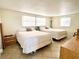 Bright bedroom featuring two beds, neutral tones, and ample natural light from the window at 5128 Perennial Dr, Holiday, FL 34690