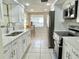 Modern kitchen with white cabinets, stainless steel appliances, and ample counter space at 5128 Perennial Dr, Holiday, FL 34690