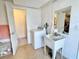 Laundry room features a washing machine, utility sink, and door leading to a toilet room at 5128 Perennial Dr, Holiday, FL 34690