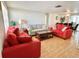 Spacious living room with tile floors and plenty of natural light from large windows at 5128 Perennial Dr, Holiday, FL 34690