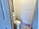 Small toilet room featuring a white toilet, purple floor tile, and simple decor at 5128 Perennial Dr, Holiday, FL 34690