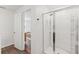 Modern bathroom with a glass-enclosed shower and a view into the bedroom beyond an open door at 5383 Companion Ln, Tampa, FL 33619