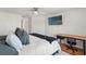 Spacious bedroom with a ceiling fan, mounted TV, and a work desk set up near the bed at 5383 Companion Ln, Tampa, FL 33619