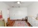 Bright Bedroom featuring a crib, changing table, patterned rug and wood flooring at 5383 Companion Ln, Tampa, FL 33619