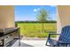 View from covered patio featuring outdoor cooking area and chair overlooking green space at 5383 Companion Ln, Tampa, FL 33619
