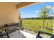View from covered patio featuring outdoor cooking area overlooking green space at 5383 Companion Ln, Tampa, FL 33619