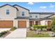 Inviting two-story townhome featuring a well-maintained lawn, attached garage, and neutral color palette at 5383 Companion Ln, Tampa, FL 33619