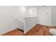 Upstairs hallway features wood floors and a railing, offering a glimpse into the home's layout at 5383 Companion Ln, Tampa, FL 33619