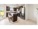 Modern kitchen featuring stainless steel appliances, granite countertops, and an island with seating at 5383 Companion Ln, Tampa, FL 33619