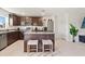 Well-lit kitchen features stainless steel appliances, granite counters, and an island with bar seating at 5383 Companion Ln, Tampa, FL 33619