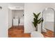 Upstairs hallway with wood flooring featuring a laundry room, mirror and decor at 5383 Companion Ln, Tampa, FL 33619