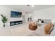 Comfortable living room with a large sectional sofa, ottoman, and entertainment center with TV at 5383 Companion Ln, Tampa, FL 33619