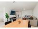 Spacious living area featuring tile floors, a modern sofa, and an adjacent dining area at 5383 Companion Ln, Tampa, FL 33619