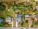 Overhead shot of the property showcasing its backyard pool, mature trees, and proximity to surrounding amenities at 5411 Joyner Ave, Spring Hill, FL 34608