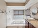 Relaxing bathroom boasts a deep soaking tub, modern fixtures, and a vanity with stone countertop at 5411 Joyner Ave, Spring Hill, FL 34608