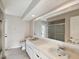 Bathroom featuring a double vanity, large mirror, and tiled shower at 5411 Joyner Ave, Spring Hill, FL 34608