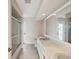 Bathroom featuring a double vanity, large mirror, and tiled shower at 5411 Joyner Ave, Spring Hill, FL 34608