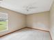 Bedroom featuring a ceiling fan, large window, and tile flooring at 5411 Joyner Ave, Spring Hill, FL 34608
