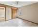 Bedroom features a ceiling fan, large window, and closet with wood louvered doors at 5411 Joyner Ave, Spring Hill, FL 34608
