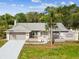 Charming single-story home featuring an attached two-car garage, a well-manicured lawn, and mature landscaping at 5411 Joyner Ave, Spring Hill, FL 34608