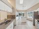 Bright kitchen with stainless steel appliances, white cabinetry, and a center island, perfect for culinary enthusiasts at 5411 Joyner Ave, Spring Hill, FL 34608