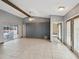 Spacious living room with tile flooring, ceiling fan, and sliding glass doors leading to outdoor pool area at 5411 Joyner Ave, Spring Hill, FL 34608