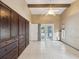 Bright living room featuring a ceiling fan, tile flooring, and access to the pool area through french doors at 5411 Joyner Ave, Spring Hill, FL 34608