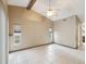 Open living space with vaulted ceilings, neutral tones, and large windows bringing in natural light at 5411 Joyner Ave, Spring Hill, FL 34608