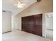Spacious living room with vaulted ceiling, ceiling fan and built in dark wood cabinets at 5411 Joyner Ave, Spring Hill, FL 34608