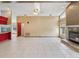 Spacious living room features tiled floors, a fireplace, and bright kitchen nearby at 5411 Joyner Ave, Spring Hill, FL 34608