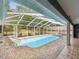 Inviting in-ground pool features a screened enclosure, offering privacy and protection from the elements at 5411 Joyner Ave, Spring Hill, FL 34608