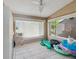 Cozy sunroom with large windows and fun inflatables at 5411 Joyner Ave, Spring Hill, FL 34608