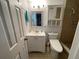 Bright bathroom featuring tiled shower with safety features, modern vanity, and comfort-height toilet at 5736 Colonial Dr, New Port Richey, FL 34653