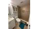 Bathroom featuring tiled walk-in shower with built-in shelves, vanity, and modern toilet at 5736 Colonial Dr, New Port Richey, FL 34653