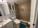 The remodeled bathroom with a tiled shower, safety bar, and modern toilet offers style and accessibility at 5736 Colonial Dr, New Port Richey, FL 34653