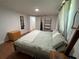 Cozy bedroom featuring wood floors, an accent mirror, and a restful color palette at 5736 Colonial Dr, New Port Richey, FL 34653
