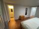 Bedroom features wood floors and is adjacent to the ensuite bathroom at 5736 Colonial Dr, New Port Richey, FL 34653