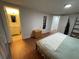Bedroom featuring wood floors, a peaceful color palette and an ensuite bathroom at 5736 Colonial Dr, New Port Richey, FL 34653