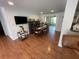 Bright dining room featuring hardwood floors, modern furnishings, and sliding glass doors to the porch at 5736 Colonial Dr, New Port Richey, FL 34653