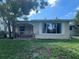 Charming home with a covered porch, neutral paint, and a well-maintained lawn at 5736 Colonial Dr, New Port Richey, FL 34653