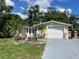 Charming single-story home with a well-manicured front yard and attached garage at 5736 Colonial Dr, New Port Richey, FL 34653