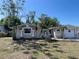 Attractive single-story home featuring stone accents, a well-kept lawn, and an attached garage at 5736 Colonial Dr, New Port Richey, FL 34653