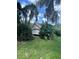 Detached garage surrounded by lush landscaping, providing a private and secluded setting at 5736 Colonial Dr, New Port Richey, FL 34653