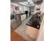 A well-equipped kitchen with stainless steel appliances, white cabinets, and sleek countertops at 5736 Colonial Dr, New Port Richey, FL 34653